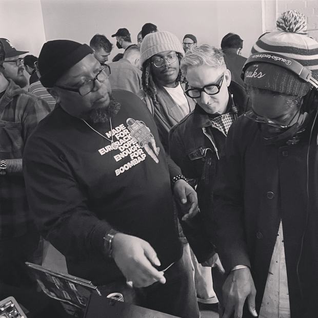 A crowd gathered around gear at a synth meet